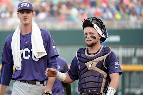 Jun 21, 2016; Omaha, NE, USA; TCU Horned Frogs pitcher Brian Howard (44) and catcher Evan Skoug (9) walk to the dugout before the start of the game against the Coastal Carolina Chanticleers in the 2016 College World Series at TD Ameritrade Park. Mandatory Credit: Steven Branscombe-USA TODAY Sports