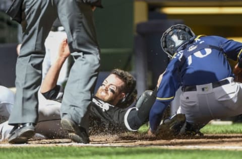 Apr 1, 2017; Milwaukee, WI, USA; Chicago White Sox left fielder Nicky Delmonico scores a run as Milwaukee Brewers catcher Rene Garcia (76) attempts to make the tag in the ninth inning at Miller Park. Mandatory Credit: Benny Sieu-USA TODAY Sports