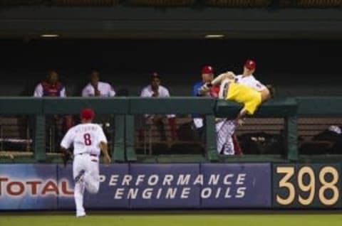 Jul 07, 2012; Philadelphia, PA, USA; Philadelphia Phillies pitcher Jonathan Papelbon (58) subdues a fan who ran onto the field and tried to get into the bullpen during the seventh inning against the Atlanta Braves at Citizens Bank Park. The Braves defeated the Phillies 6-3. Mandatory Credit: Howard Smith-US PRESSWIRE