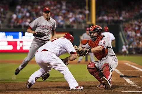 Aug 21, 2012; Philadelphia, PA, USA; Philadelphia Phillies pinch hitter Ty Wigginton (24) is tagged out by Cincinnati Reds catcher Ryan Hanigan (29) during the seventh inning at Citizens Bank Park. The Reds defeated the Phillies 5-4. Mandatory Credit: Howard Smith-US PRESSWIRE