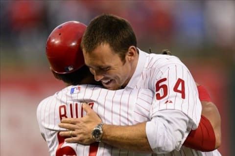 Aug 1, 2013; Philadelphia, PA, USA; Brad Lidge the Philadelphia Phillies closer from the 2008 World Series hugs catcher Carlos Ruiz (51) after he threw out the first pitch prior to the game against the San Francisco Giants at Citizens Bank Park. Mandatory Credit: Howard Smith-USA TODAY Sports