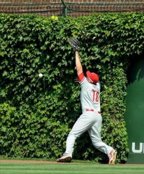 Sep 1, 2013; Chicago, IL, USA; Philadelphia Phillies first baseman Darin Ruf (18) misses a fly ball from Chicago Cubs first baseman Anthony Rizzo (not pictured) during the third inning at Wrigley Field. Mandatory Credit: Reid Compton-USA TODAY Sports