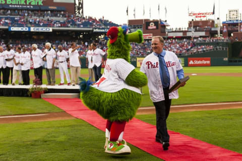 Aug 2, 2013; Philadelphia, PA, USA; Philadelphia Phillies wall of fame inductee Curt Schilling shakes hands with the Phillie Phanatic during the 2013 Philadelphia Phillies wall of fame induction ceremony prior to playing the Atlanta Braves at Citizens Bank Park. The Braves defeated the Phillies 6-4. Mandatory Credit: Howard Smith-USA TODAY Sports