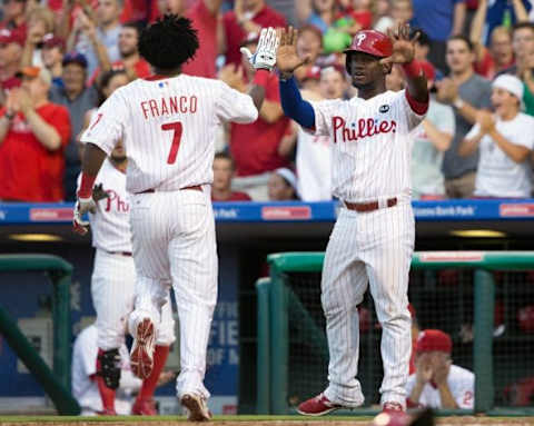 Jul 31, 2015; Philadelphia, PA, USA; Philadelphia Phillies third baseman Maikel Franco (7) and center fielder Odubel Herrera (37) congratulate each other after scoring against the Atlanta Braves during the first inning at Citizens Bank Park. Mandatory Credit: Bill Streicher-USA TODAY Sports