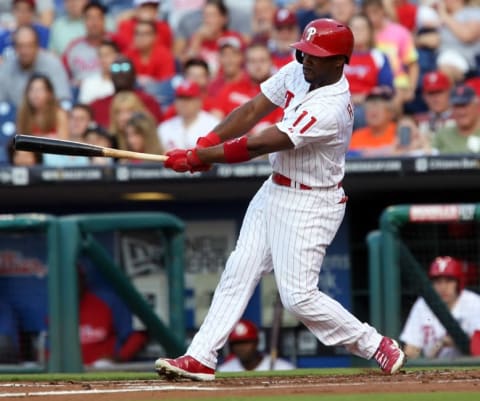 Aug 6, 2014; Philadelphia, PA, USA; Philadelphia Phillies shortstop Rollins (11) hits a double to right during the first inning of a game against the Houston Astros at Citizens Bank Park. (Photo Credit: Bill Streicher-USA TODAY Sports)