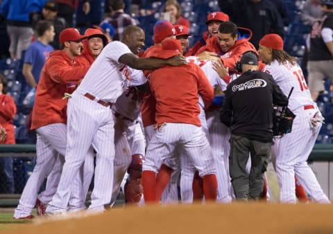 Apr 20, 2016; Philadelphia, PA, USA; The Philadelphia Phillies mob right fielder Bourjos (17) after his walk off single during the eleventh inning against the New York Mets at Citizens Bank Park. The Philadelphia Phillies won 5-4 in the eleventh inning. (Photo Credit: Bill Streicher-USA TODAY Sports)