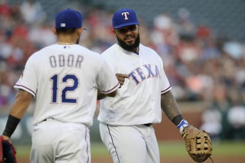 Apr 25, 2016; Arlington, TX, USA; Texas Rangers first baseman Fielder (84) is congratulated by second baseman Odor (12) after making a throw to home plate for an out in the second inning against the New York Yankees at Globe Life Park in Arlington. (Photo Credit: Tim Heitman-USA TODAY Sports)