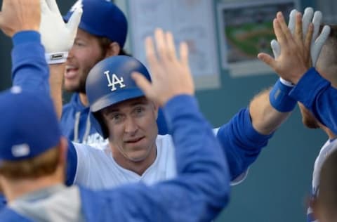 May 24, 2016; Los Angeles, CA, USA; Los Angeles Dodgers second baseman Chase Utley (26) is greeted in the dugout after scoring a run in the first inning of the game against the Cincinnati Reds on a single by shortstop Corey Seager (5) at Dodger Stadium. Mandatory Credit: Jayne Kamin-Oncea-USA TODAY Sports