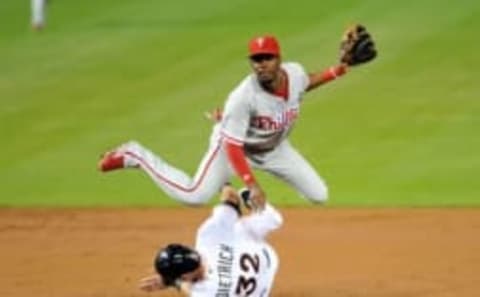 Sep 23, 2015; Miami, FL, USA; Miami Marlins left fielder Derek Dietrich (32) is forced out at second base as Philadelphia Phillies second baseman Darnell Sweeney (24) turns the double play during the second inning at Marlins Park. Mandatory Credit: Steve Mitchell-USA TODAY Sports