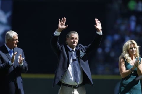 Aug 8, 2015; Seattle, WA, USA; Former Seattle Mariners manager Lou Piniella (left) and wife Karen Moyer (right) clap as former Seattle Mariners pitcher Jamie Moyer is inducted into the Mariners Hall of Fame before the start of a game Texas Rangers at Safeco Field. Mandatory Credit: Jennifer Buchanan-USA TODAY Sports