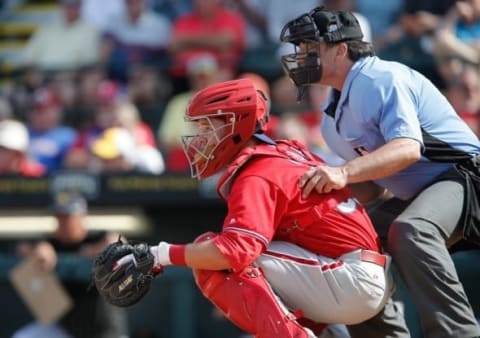 Mar 7, 2016; Bradenton, FL, USA; Philadelphia Phillies catcher Andrew Knapp (80) catches as umpire Phil Cuzzi (10) looks on during the seventh inning of a spring training baseball game against the Pittsburgh Pirates at McKechnie Field. The Phillies won 1-0. Mandatory Credit: Reinhold Matay-USA TODAY Sports