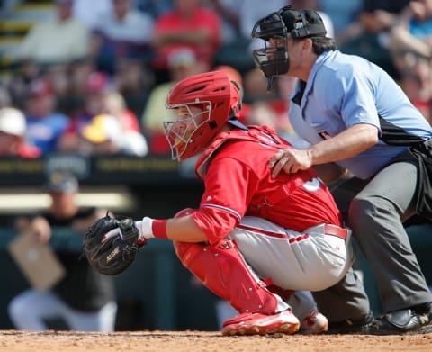 Mar 7, 2016; Bradenton, FL, USA; Philadelphia Phillies catcher Andrew Knapp (80) catches as umpire Phil Cuzzi (10) looks on during the seventh inning of a spring training baseball game against the Pittsburgh Pirates at McKechnie Field. The Phillies won 1-0. Mandatory Credit: Reinhold Matay-USA TODAY Sports