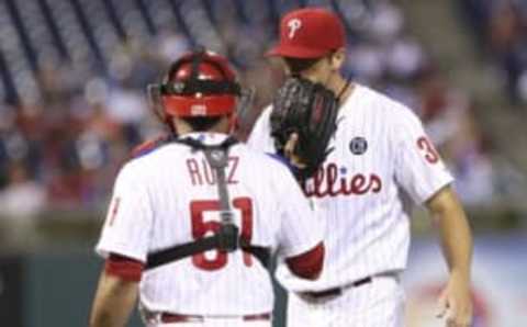 Aug 26, 2014; Philadelphia, PA, USA; Philadelphia Phillies starting pitcher Cole Hamels (35) and catcher Carlos Ruiz (51) talk on the mound during the sixth inning of a game against the Washington Nationals at Citizens Bank Park. The Phillies defeated the Nationals 4-3. Mandatory Credit: Bill Streicher-USA TODAY Sports