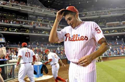 Jul 5, 2016; Philadelphia, PA, USA; Philadelphia Phillies starting pitcher Eflin (56) reacts after getting Powerade dumped on him by right fielder Paredes (41) and second baseman Blanco (4)after beating the Atlanta Braves and picking up his first major league win at Citizens Bank Park. The Phillies defeated the Braves, 5-1. Mandatory Credit: Eric Hartline-USA TODAY Sports