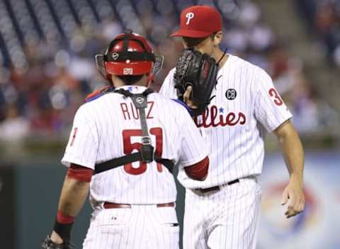 Aug 26, 2014; Philadelphia, PA, USA; Philadelphia Phillies starting pitcher Hamels (35) and catcher Ruiz (51) talk on the mound during the sixth inning of a game against the Washington Nationals at Citizens Bank Park. The Phillies defeated the Nationals 4-3. Mandatory Credit: Bill Streicher-USA TODAY Sports