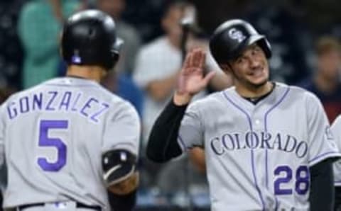 Jun 5, 2016; San Diego, CA, USA; Colorado Rockies third baseman Nolan Arenado (28) congratulates right fielder Carlos Gonzalez (5) after Gonzalez hit a two run home run during the ninth inning against the San Diego Padres at Petco Park. Mandatory Credit: Jake Roth-USA TODAY Sports