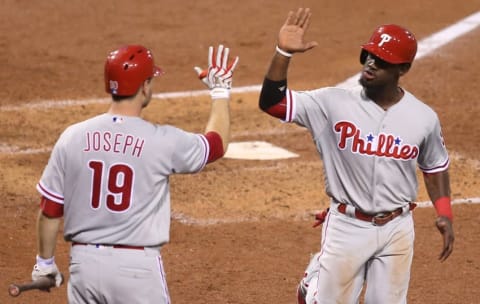 Jul 22, 2016; Pittsburgh, PA, USA; Philadelphia Phillies first baseman Joseph (19) greets center fielder Herrera (R) after Herrara scored a run against the Pittsburgh Pirates during the seventh inning at PNC Park. Mandatory Credit: Charles LeClaire-USA TODAY Sports