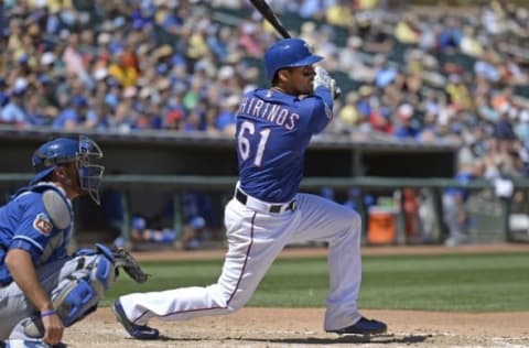 Mar 30, 2016; Surprise, AZ, USA; Texas Rangers catcher Chirinos (61) doubles during the fifth inning against the Kansas City Royals at Surprise Stadium. Mandatory Credit: Jake Roth-USA TODAY Sports