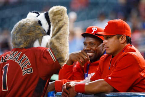 Jun 29, 2016; Phoenix, AZ, USA; Philadelphia Phillies catcher Ruiz (right) and first baseman Howard (center) joke with Arizona Diamondbacks mascot Baxter at Chase Field. Mandatory Credit: Mark J. Rebilas-USA TODAY Sports