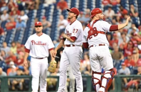 Jul 18, 2016; Philadelphia, PA, USA; Philadelphia Phillies starting pitcher Nola (27) reacts after being hit by a line drive as catcher Rupp (29) calls for time during the sixth inning against the Miami Marlins at Citizens Bank Park. The Marlins defeated the Phillies, 3-2 in 11 innings. Mandatory Credit: Eric Hartline-USA TODAY Sports