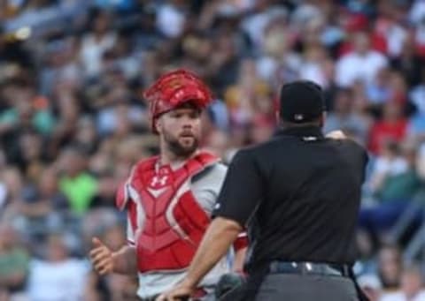 Jul 22, 2016; Pittsburgh, PA, USA; Philadelphia Phillies catcher Rupp (29) reacts as home plate umpire Tony Randazzo (R) addresses both benches during the first inning at PNC Park. Mandatory Credit: Charles LeClaire-USA TODAY Sports