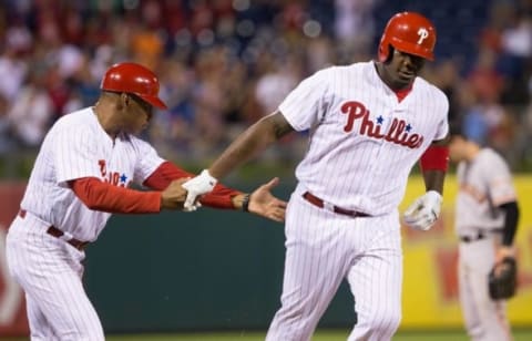 Aug 3, 2016; Philadelphia, PA, USA; Philadelphia Phillies first baseman Ryan Howard (6) is congratulated by third base coach Juan Samuel (8) after hitting a home run during the seventh inning against the San Francisco Giants at Citizens Bank Park. The Philadelphia Phillies won 5-4 in the twelfth inning. Mandatory Credit: Bill Streicher-USA TODAY Sports