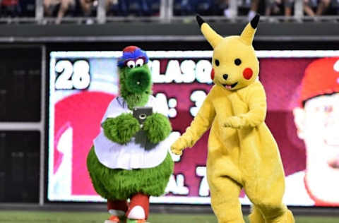 Jul 19, 2016; Philadelphia, PA, USA; The Phillie Phanatic tries to capture Pikachu during a break in the game between the Philadelphia Phillies and the Miami Marlins at Citizens Bank Park. The Marlins defeated the Phillies 2-1 in 10 innings. Mandatory Credit: Eric Hartline-USA TODAY Sports