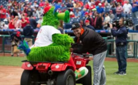 May 18, 2016; Philadelphia, PA, USA; Miami Marlins starting pitcher Fernandez (16) attempts to steal the keys of the Phillie Phanatic