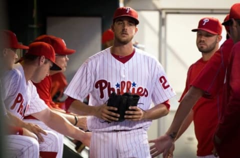 Jun 16, 2016; Philadelphia, PA, USA; Philadelphia Phillies starting pitcher Nola (27) walks past teammates in the dugout after being relieved in the fourth inning against the Toronto Blue Jays at Citizens Bank Park. Mandatory Credit: Bill Streicher-USA TODAY Sports