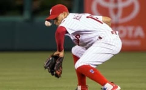 Jun 16, 2016; Philadelphia, PA, USA; Philadelphia Phillies second baseman Cesar Hernandez (16) is hit in the face on a ground ball hit by Toronto Blue Jays first baseman Justin Smoak (not pictured) during the ninth inning at Citizens Bank Park. The Toronto Blue Jays won 13-2. Mandatory Credit: Bill Streicher-USA TODAY Sports