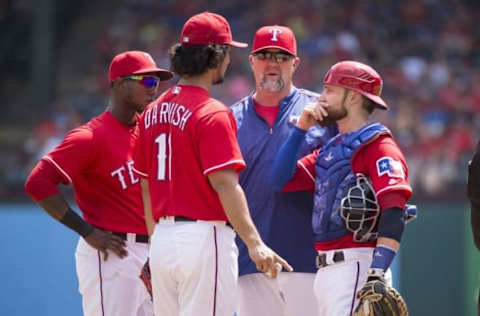 Sep 4, 2016; Arlington, TX, USA; Texas Rangers pitching coach Doug Brocail (46) talks with starting pitcher Darvish (11) as shortstop Profar (19) and catcher Lucroy (25) look on during the first inning against the Houston Astros at Globe Life Park in Arlington. Mandatory Credit: Jerome Miron-USA TODAY Sports