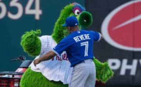 Aug 18, 2015; Philadelphia, PA, USA; The Phillie Phanatic greets Toronto Blue Jays left fielder Ben Revere (7) before a game at Citizens Bank Park. The Blue Jays won 8-5. Mandatory Credit: Bill Streicher-USA TODAY Sports