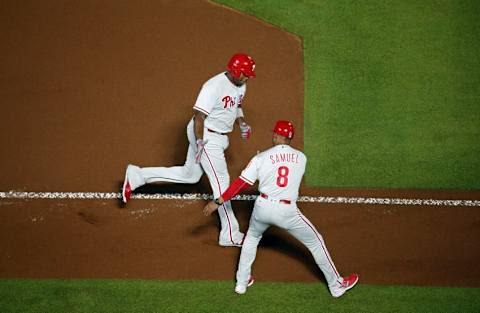 Sep 27, 2016; Atlanta, GA, USA; Philadelphia Phillies first baseman Ryan Howard (6) celebrates his grand slam with third base coach Juan Samuel (8) in the first inning of their game against the Atlanta Braves at Turner Field. Mandatory Credit: Jason Getz-USA TODAY Sports