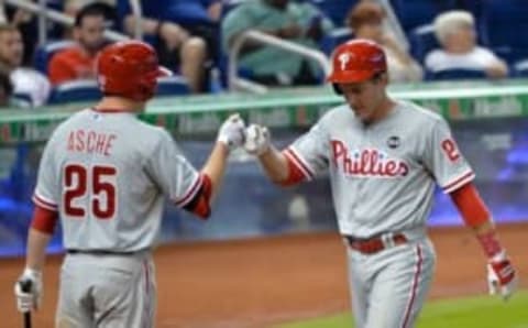 May 3, 2015; Miami, FL, USA; Philadelphia Phillies second baseman Chase Utley (R) fist bumps third baseman Cody Asche (L) after scoring a run during the seventh inning against the Miami Marlins at Marlins Park. Mandatory Credit: Steve Mitchell-USA TODAY Sports