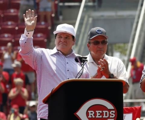 Jun 26, 2016; Cincinnati, OH, USA; Former Cincinnati Reds player Pete Rose (left) waves to the crowd during his number retirement ceremony prior to a game with the San Diego Padres at Great American Ball Park. Mandatory Credit: David Kohl-USA TODAY Sports