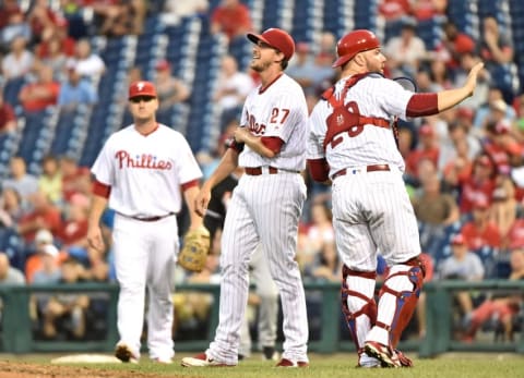 Jul 18, 2016; Philadelphia, PA, USA; Philadelphia Phillies starting pitcher Aaron Nola (27) reacts after being hit by a line drive as catcher Cameron Rupp (29) calls for time during the sixth inning against the Miami Marlins at Citizens Bank Park. The Marlins defeated the Phillies, 3-2 in 11 innings. Mandatory Credit: Eric Hartline-USA TODAY Sports