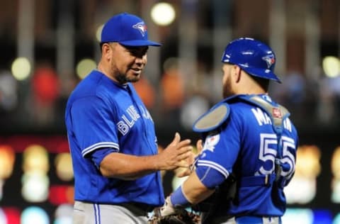 Aug 29, 2016; Baltimore, MD, USA; Toronto Blue Jays pitcher Joaquin Benoit (left) reacts with catcher Russell Martin (right) after beating the Baltimore Orioles 5-1 at Oriole Park at Camden Yards. Mandatory Credit: Evan Habeeb-USA TODAY Sports