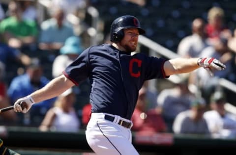 Mar 23, 2015; Goodyear, AZ, USA; Cleveland Indians first baseman Brandon Moss (44) reacts after hitting in the fifth against the Oakland Athletics during a spring training game at Goodyear Ballpark. Mandatory Credit: Rick Scuteri-USA TODAY Sports