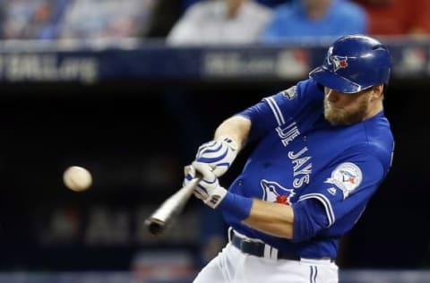 Oct 19, 2016; Toronto, Ontario, CAN; Toronto Blue Jays left fielder Michael Saunders (21) hits a single during the fifth inning against the Cleveland Indians in game five of the 2016 ALCS playoff baseball series at Rogers Centre. Mandatory Credit: John E. Sokolowski-USA TODAY Sports