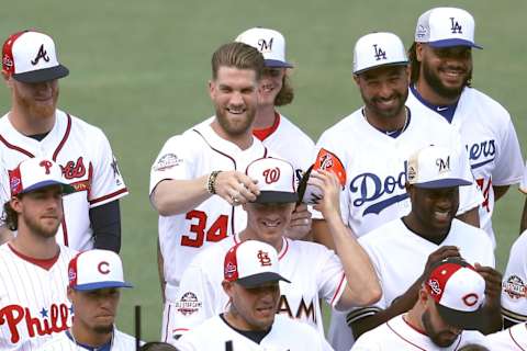 WASHINGTON, DC – JULY 16: Bryce Harper #34 of the Washington Nationals switches hats with J.T. Realmuto #11 of the Miami Marlins during the National League All-Star team photo during Gatorade All-Star Workout Day at Nationals Park on July 16, 2018 in Washington, DC. (Photo by Rob Carr/Getty Images)