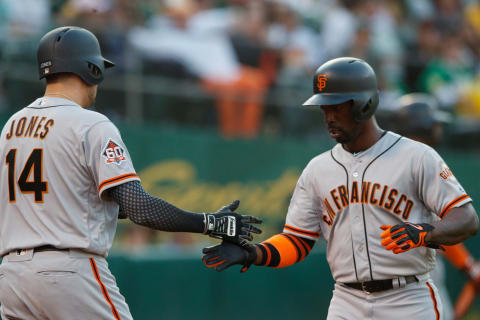 OAKLAND, CA – JULY 20: Andrew McCutchen #22 of the San Francisco Giants is congratulated by Ryder Jones #14 after scoring a run against the Oakland Athletics during the fourth inning at the Oakland Coliseum on July 20, 2018 in Oakland, California. (Photo by Jason O. Watson/Getty Images)