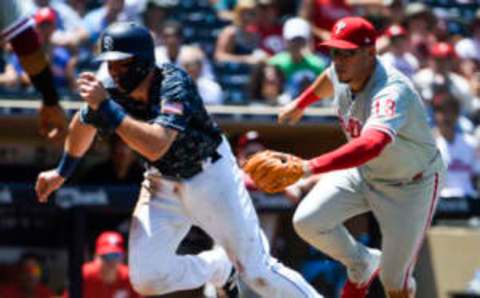 SAN DIEGO, CA – AUGUST 12: Eric Hosmer #30 of the San Diego Padres is tagged out in a run down between third and home by Asdrubal Cabrera #13 of the Philadelphia Phillies during the second inning of a baseball game at PETCO Park on August 12, 2018 in San Diego, California. (Photo by Denis Poroy/Getty Images)