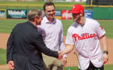 CLEARWATER, FL – MARCH 2: John Middleton, Philadelphia Phillies managing parter, shakes hands with Bryce Harper as general manager Matt Klentak looks on during the press conference introducing Harper as a member of the Philadelphia Phillies on Saturday March 2, 2019 at Spectrum Field in Clearwater, Florida. (Photo by Mike Carlson/MLB via Getty Images)