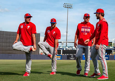 TAMPA, FL – MARCH 13: (L-R) J.T. Realmuto #10, Drew Butera #41, Rhys Hoskins #17, and Bryce Harper #3 of the Philadelphia Phillies warm up before the spring training game against the New York Yankees at Steinbrenner Field on March 13, 2019 in Tampa, Florida. (Photo by Mark Brown/Getty Images)