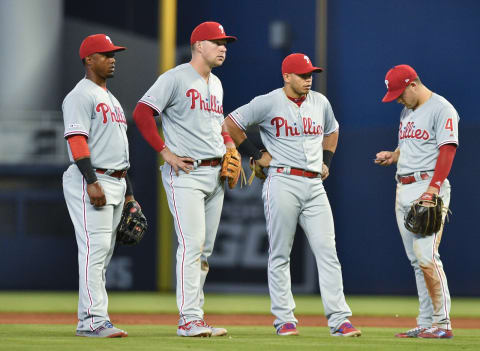 MIAMI, FL – APRIL 14: Jean Segura #2, Rhys Hoskins #17, Cesar Hernandez #16, and Scott Kingery #4 of the Philadelphia Phillies wait during a pitching change against the Miami Marlins at Marlins Park on April 14, 2019 in Miami, Florida. (Photo by Mark Brown/Getty Images)