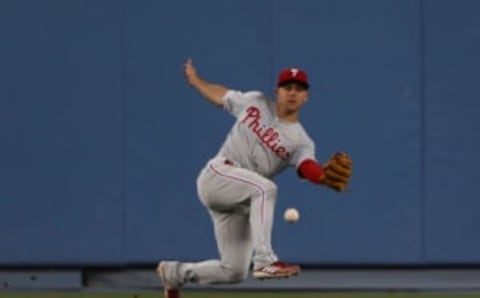 LOS ANGELES, CALIFORNIA – JUNE 01: Scott Kingery #4 of the Philadelphia Phillies slips as he fields a hit to center field in the third inning of the MLB game against the Los Angeles Dodgers at Dodger Stadium on June 01, 2019 in Los Angeles, California. (Photo by Victor Decolongon/Getty Images)