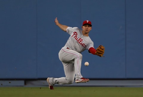 LOS ANGELES, CALIFORNIA – JUNE 01: Scott Kingery #4 of the Philadelphia Phillies slips as he fields a hit to center field in the third inning of the MLB game against the Los Angeles Dodgers at Dodger Stadium on June 01, 2019 in Los Angeles, California. (Photo by Victor Decolongon/Getty Images)