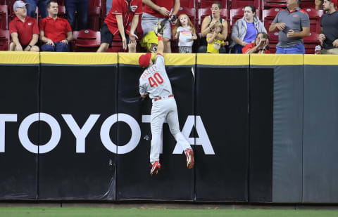 CINCINNATI, OHIO – SEPTEMBER 04: Adam Haseley #40 of the Philadelphia Phillies reaches up above the outfield wall to catch the ball hit by the Freddy Galvis #3 of the Cincinnati Reds at Great American Ball Park on September 04, 2019 in Cincinnati, Ohio. (Photo by Andy Lyons/Getty Images)