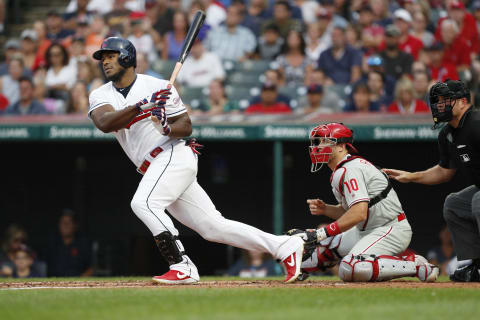 CLEVELAND, OH – SEPTEMBER 22: Yasiel Puig #66 of the Cleveland Indians bats as J.T. Realmuto #10 of the Philadelphia Phillies looks on in the first inning at Progressive Field on September 22, 2019 in Cleveland, Ohio. The Indians defeated the Phillies 10-1. (Photo by David Maxwell/Getty Images)