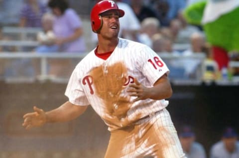 Philadelphia Phillies’ Travis Lee looks back at homeplate umpire Brian Runge who called him out on a close play in the third inning against the New York Mets 02 July 2002 at Veterans Stadium in Philadelphia, PA. Lee appeared to have reached the plate before catcher Mike Piazza tagged him with the ball. AFP PHOTO/TOM MIHALEK (Photo by TOM MIHALEK / AFP) (Photo by TOM MIHALEK/AFP via Getty Images)